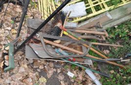 A GALVANISED WHEELBARROW CONTAINING GARDEN TOOLS including shovels, spades, rakes, etc