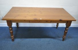 A MODERN PINE RECTANGULAR TABLE, with a single frieze drawer, raised on block and turned legs,