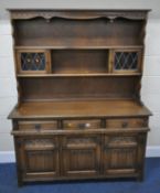 AN OLD CHARM OAK DRESSER, the two tier plate rack fitted with two lead glazed doors, atop a base