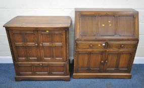 AN ERCOL ELM AND BEECH BUREAU, the fall front door enclosing a fitted interior, over two drawers and