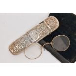 A LATE VICTORIAN SILVER GLASSES CASE AND A CASED PAIR OF GLASSES, the silver case with foliate