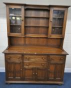 AN ERCOL ELM AND BEECH DRESSER, the three tier plate rack with two glass doors, and an arrangement