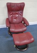 A RED LEATHER EKORNES STRESSLESS RECLINING SWIVEL ARMCHAIR, width 77cm x depth 74cm x height