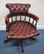 A REPRODUCTION SWIVEL OFFICE CHAIR, with buttoned oxblood leather upholstery, width 61cm x depth