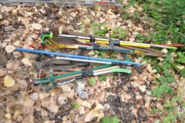 A COLLECTION OF GARDEN TOOLS including axes, rakes, hoes, etc
