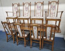 AN ERCOL ELM AND BEECH EXTENDING DINING TABLE, with three additional leaves, raised on turned