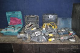 A COLLECTION OF 110V POWER TOOLS including two Bosch jigsaw, a Makita router and electric planer,