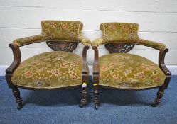 A PAIR OF EARLY 20TH CENTURY OAK ARMCHAIRS, with foliate upholstery, open armrests, raised on turned