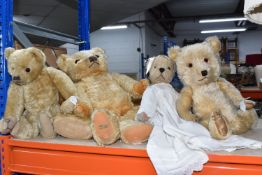 A GROUP OF FIVE TEDDY BEARS to include one with a Merrythought tag stitched to the foot, height