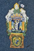 A CONTINENTAL TIN GLAZED HOLY WATER STOOP, with figures and columns in relief, around a central