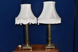 A PAIR OF BRASS TABLE LAMPS in a neo-classical form, a square acanthus patterned base with central