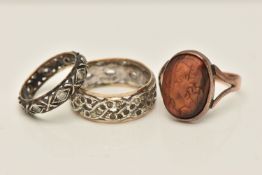 THREE RINGS, the first a yellow metal carved tigers eye cabochon, collet set to the bifurcated