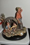 A CAPODIMONTE 'LA BURLA' FIGURE GROUP, depicting two boys hiding from a farmer inside a barrel,