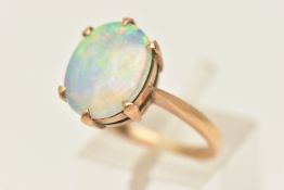 AN OPAL RING, oval opal approximate length 12mm x width 10mm, six prong set in yellow metal, pinched