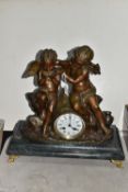 A BRONZE AND MARBLE FIGURAL MANTEL CLOCK, in the form of two putti seated on a rock, one drinking