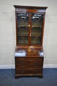 AN EDWARDIAN MAHOGANY AND BOX STRUNG BUREAU BOOKCASE, the double glazed doors enclosing three