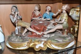 A CAPODIMONTE PORCELAIN FIGURE GROUP OF FOUR BOYS PLAYING CARDS on a naturalist base, a gilt