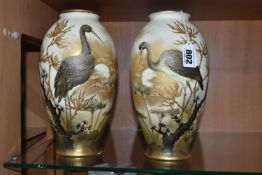 A PAIR OF ERNST WAHLISS VIENNA VASES, of footed ovoid form, each painted with a roosting stork on