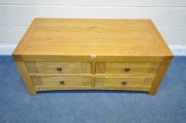 A MODERN OAK COFFEE TABLE, fitted with four double sided drawers, width 120cm x depth 60cm x