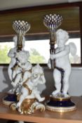 A GROUP OF CHERUB THEMED ORNAMENTS comprising a pair of Copeland cherub figurative candlesticks in