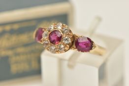 AN EARLY 20TH CENTURY 18CT GOLD RUBY AND DIAMOND CLUSTER RING, designed as a circular cluster set