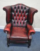 AN OXBLOOD LEATHER CHESTERFIELD STYLE WING BACK ARMCHAIR, raised on cabriole legs, width 85cm x