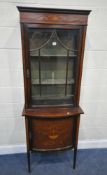 AN EDWARDIAN MAHOGANY AND MARQUETRY INLAID DISPLAY CABINET, the single glass door enclosing two