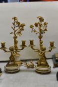 TWO PAIRS OF FIGURAL GILT METAL CANDELABRA, comprising a pair of two branch candelabra, possibly