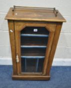 A VICTORIAN WALNUT PIER CABINET, with a raised brass gallery, the single glass door enclosing an