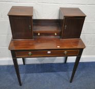 AN EDWARDIAN MAHOGANY AND INLAID DESK, with two cupboard doors, flanking a central drawer, atop a