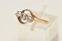 A THREE STONE DIAMOND RING, three old cut diamonds, prong set in white metal, yellow metal curved