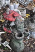 THREE CONCRETE GARDEN ORNAMENTS, including a toadstool house, a toadstool with a toad atop, and a