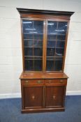 BARTHOLOMEW AND FLETCHER, AN EDWARDIAN MAHOGANY AND CROSS BANDED BOOKCASE, the double glass doors