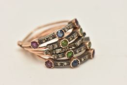 A 19TH CENTURY MULTI GEM SET HAREEM RING, comprised of five yellow metal stacked bands conjoined