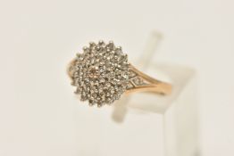 A 9CT GOLD DIAMOND CLUSTER RING, a domed cluster of single cut diamonds, leading on to bifurcated
