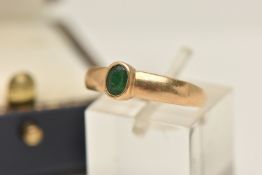 A 9CT GOLD EMERALD RING, set with an oval cut emerald collet setting to the polished band,