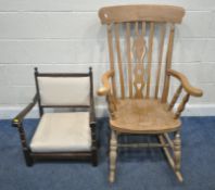 A BEECH FRAMED ROCKING CHAIR, with a central splat, scrolled armrests, raised on turned supports,