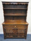 A LATE 20TH CENTURY OAK DRESSER, the two tier plate rack atop a base fitted with two drawers, over