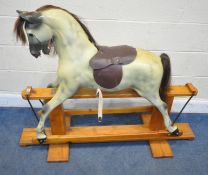 HADDON ROCKERS, A 20TH CENTURY FIBREGLASS DAPPLE ROCKING HORSE, the head turned slightly to the