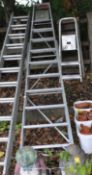 A LARGE ALUMINIUM STEP LADDER, with nine rungs and shelf top step, height 310cm, and two step