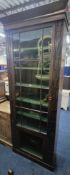 A TALL MAHOGANY BOOKCASE, with an overhanging cornice, the single glazed door enclosing six shelves,