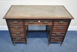 AN EARLY 20TH CENTURY MAHOGANY KNEE HOLE DESK, fitted with a leather writing surface, nine