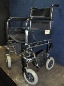 A VINTAGE WHEELCHAIR with two footrests