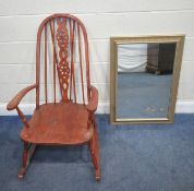 A STAINED WHEEL BACK ROCKING CHAIR, width 63cm x depth 79cm x height 108cm, along with a wall