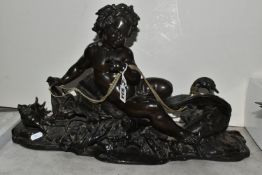 A BRONZED SCULPTURE OF A CHERUB AND A SWAN, the cherub seated inside a large clam shell and