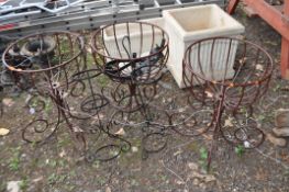 SEVEN COATED STEEL GARDEN ITEMS, including three floor standing basket frames, two hanging basket