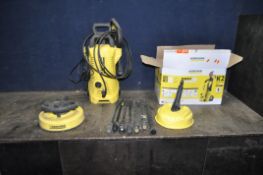 A KARCHER K2 PRESSURE WASHER with two patio heads, four nozzles, lance, three extensions and