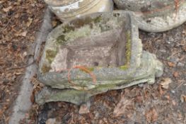 A DUKE FOREST LIMITED CONCRETE WHEELBARROW PLANTER, with heavily detailed top on a separate base,
