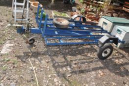 A STEEL FRAMED MOTORCYCLE TRAILER, with three tracks for three bikes, one ramp, spare wheel,