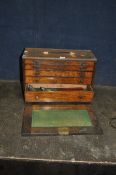 A MID-CENTURY OAK ENGINEERS TOOL CABINET, with five graduated drawers, concealed by a front panel
